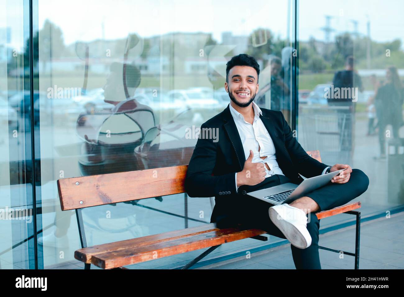 Cool guy arabic man uses laptop business center Stock Photo