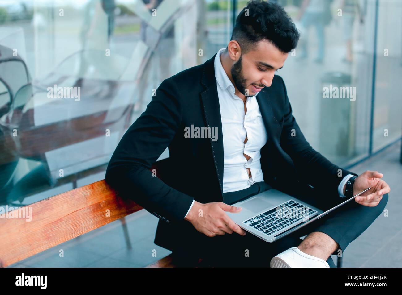 Cool guy arabic man uses laptop business center Stock Photo
