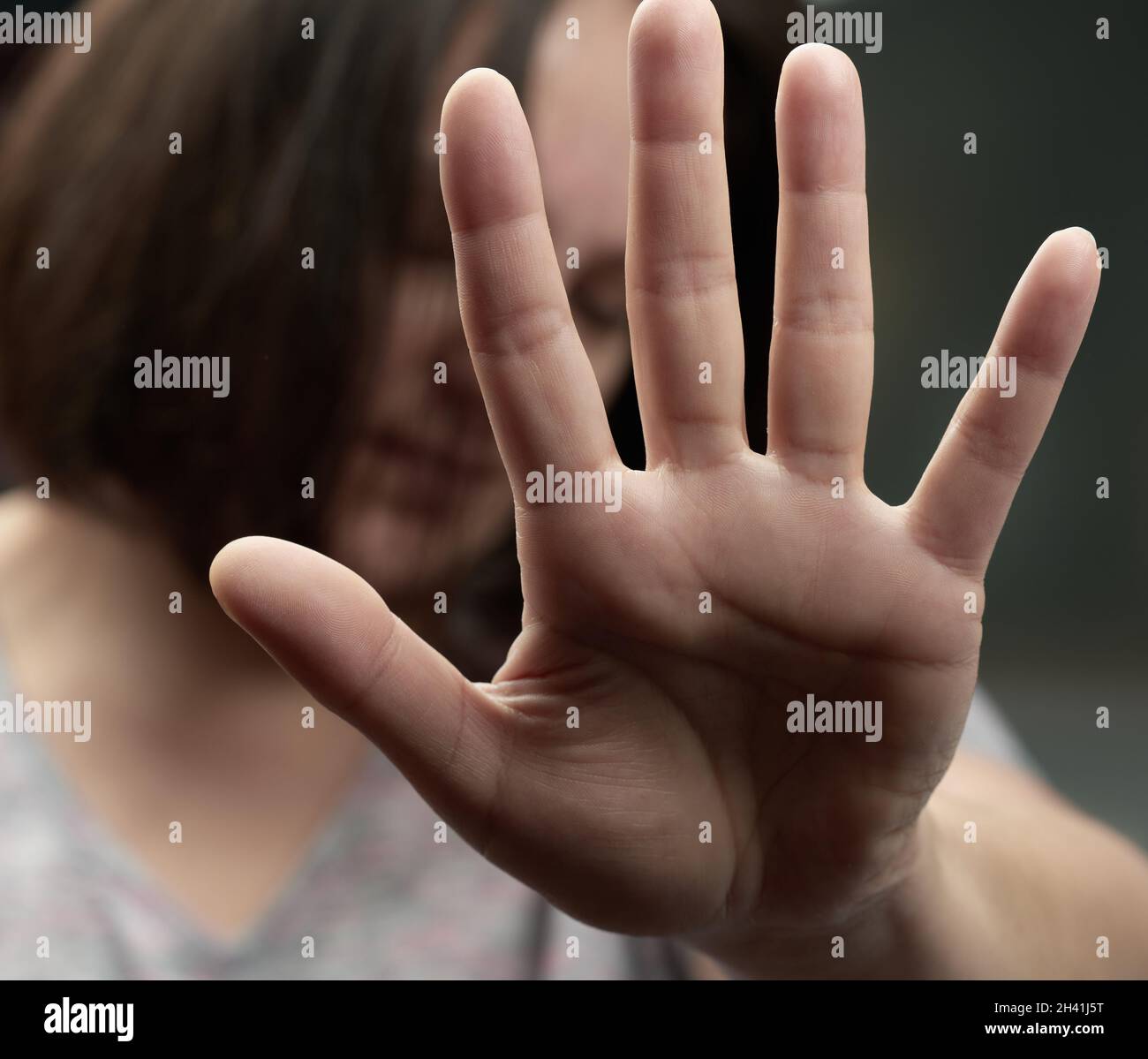 Woman stretched her palm forward, gesture of rejection of the offer, protection from violence. Stop Stock Photo