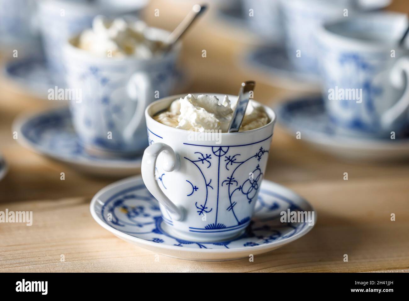 Cups filled with phariseer and cream stand on a table Stock Photo