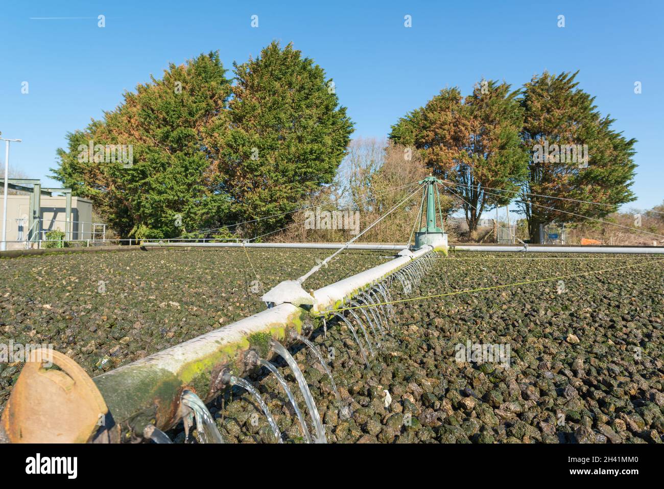 Rotary arm discharging waste water on filter bed, sewage treatment works Stock Photo Alamy