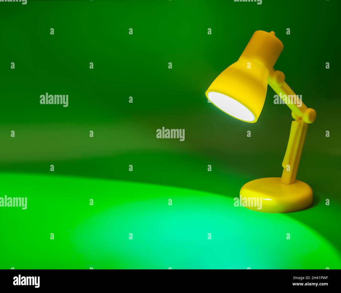Desk lamp on green Stock Photo