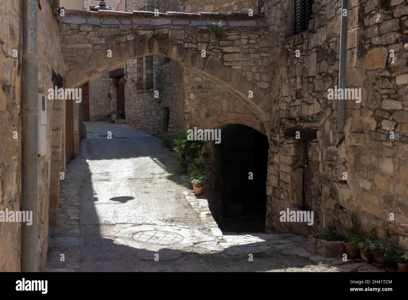 medieval street with an arch in the town of Guimerá in Catalunya Stock Photo