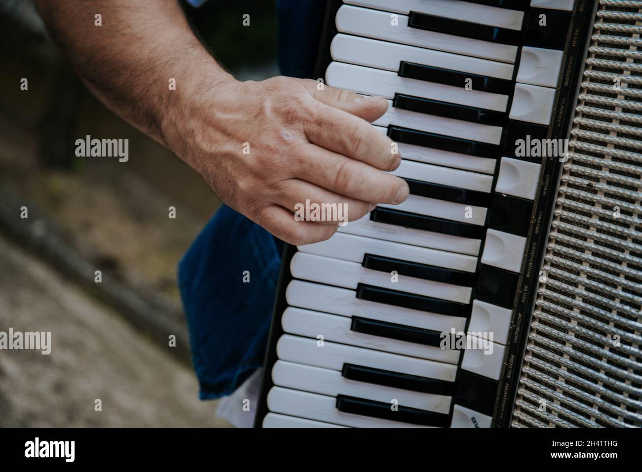 A closeup shot on a musician man's hand playing on keyboard instrument Stock Photo