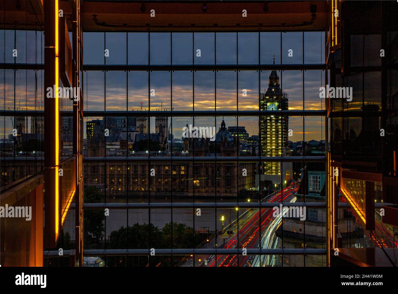 A reflection of Big Ben, the Houses of Paliament and traffic going over Westminster Bridge from an unusual angle Stock Photo