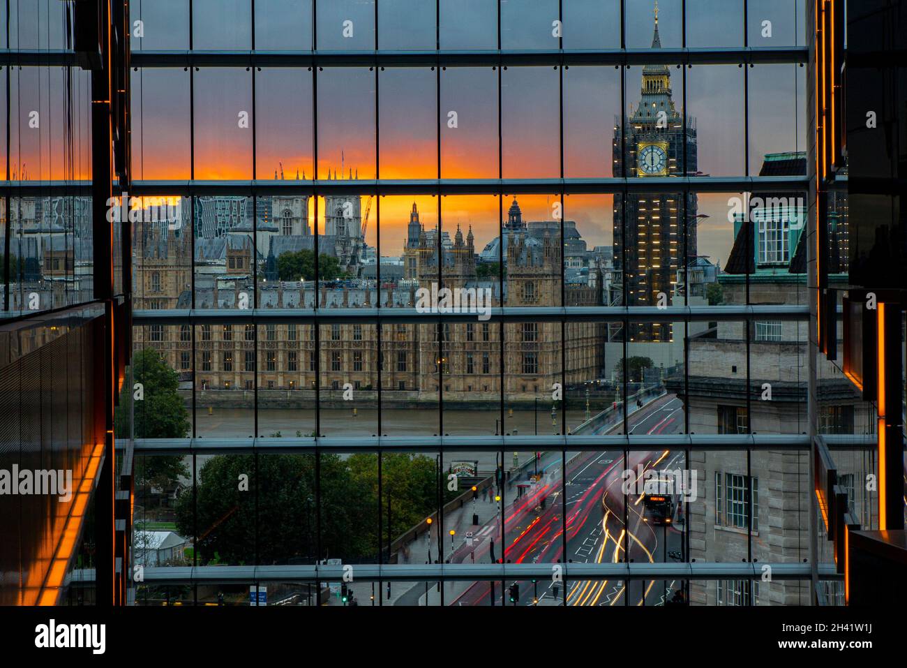 A reflection of Big Ben, the Houses of Paliament and traffic going over Westminster Bridge from an unusual angle Stock Photo