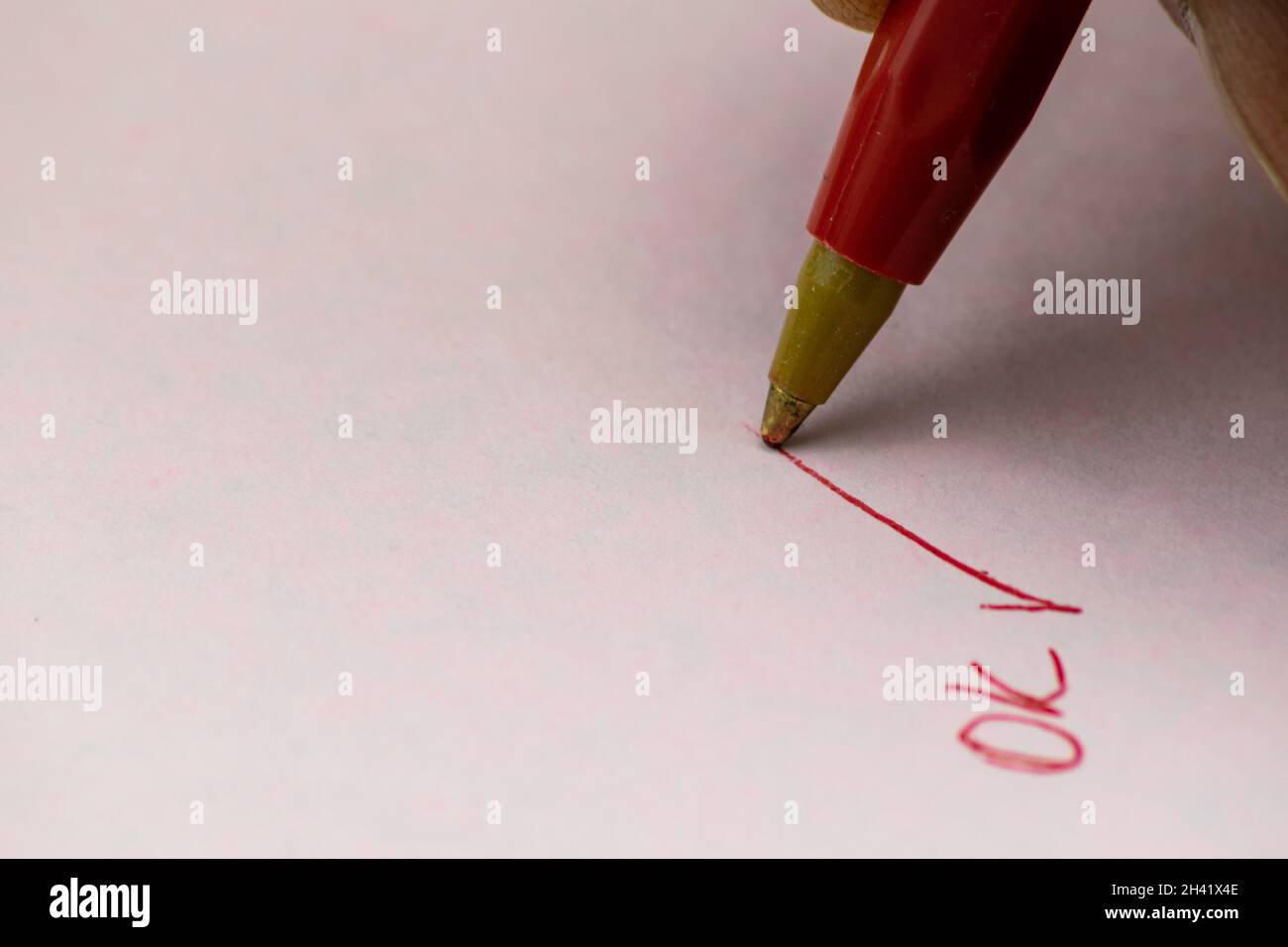 Close-up of chip pen marking an OK, as a goal accomplished Stock Photo