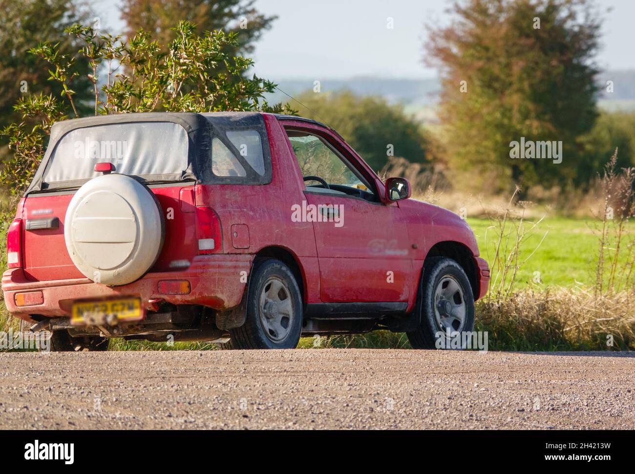 Red Suzuki Grand Vitara GV1600 off-road driving across Salisbury Plain, Wiltshire UK Stock Photo