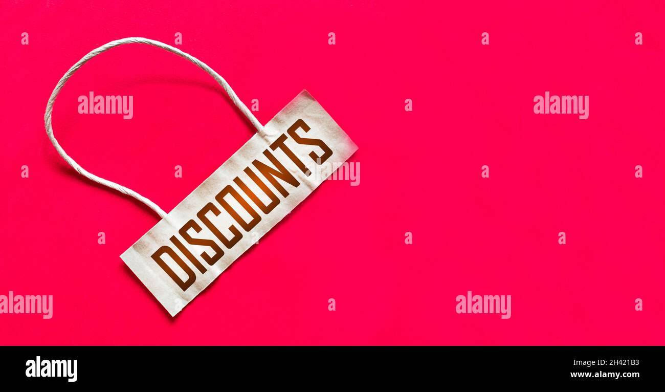 On A Red Background There Is A Price Tag With The Text Discounts Sale