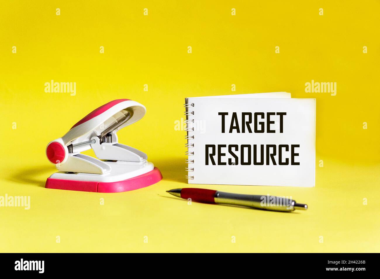 Target resource text on notepad and yellow background with stapler and pen Stock Photo Alamy