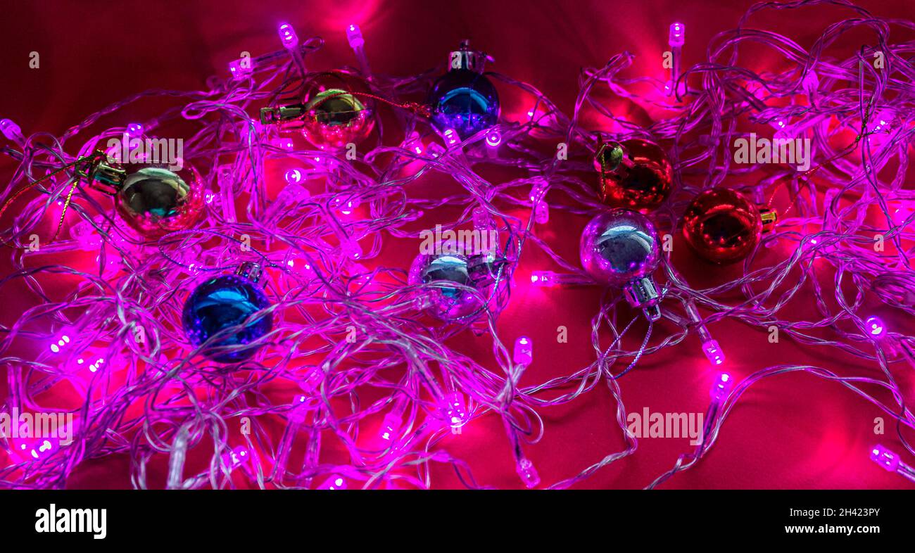 Christmas garland in purple light with new year toys Stock Photo Alamy