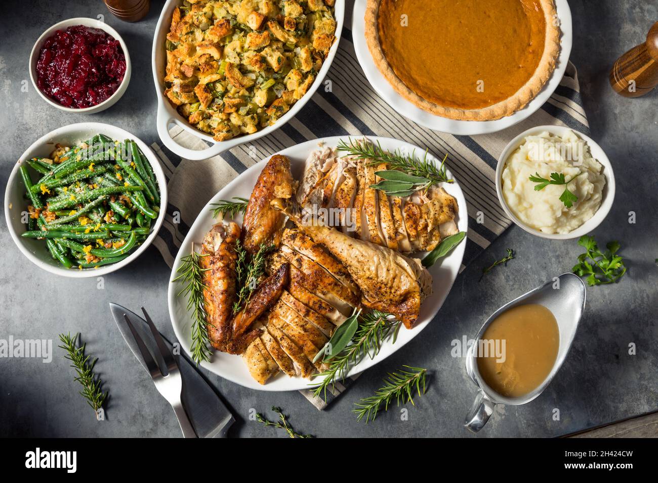 Festive Thanksgiving Day Turkey Dinner with Stuffing Pumpkin PIe and Potatoes Stock Photo