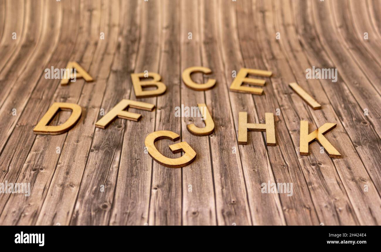 Lowercase letters of the english alphabet on wooden background Stock Photo