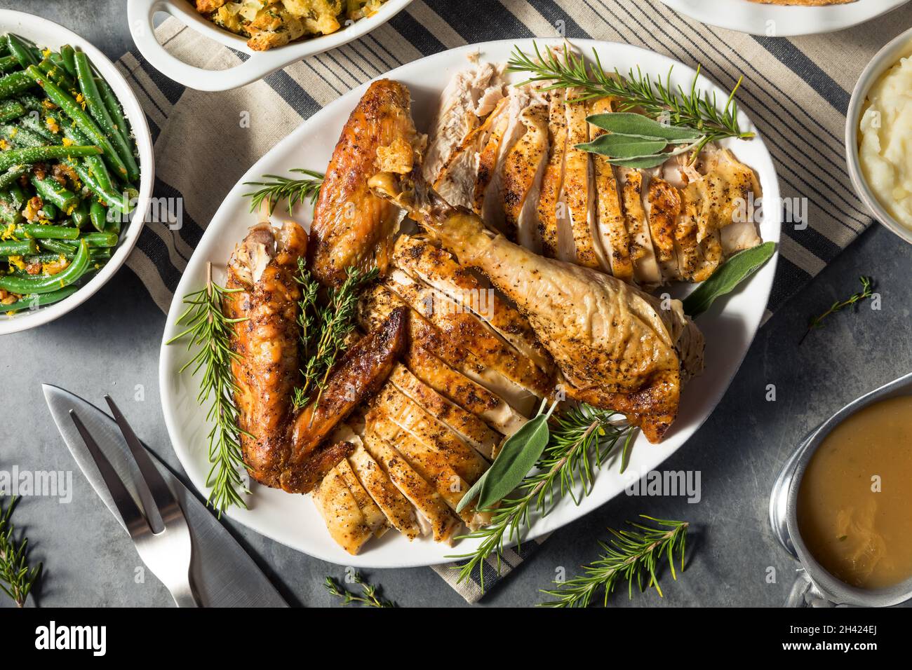 Festive Thanksgiving Day Turkey Dinner with Stuffing Pumpkin PIe and Potatoes Stock Photo