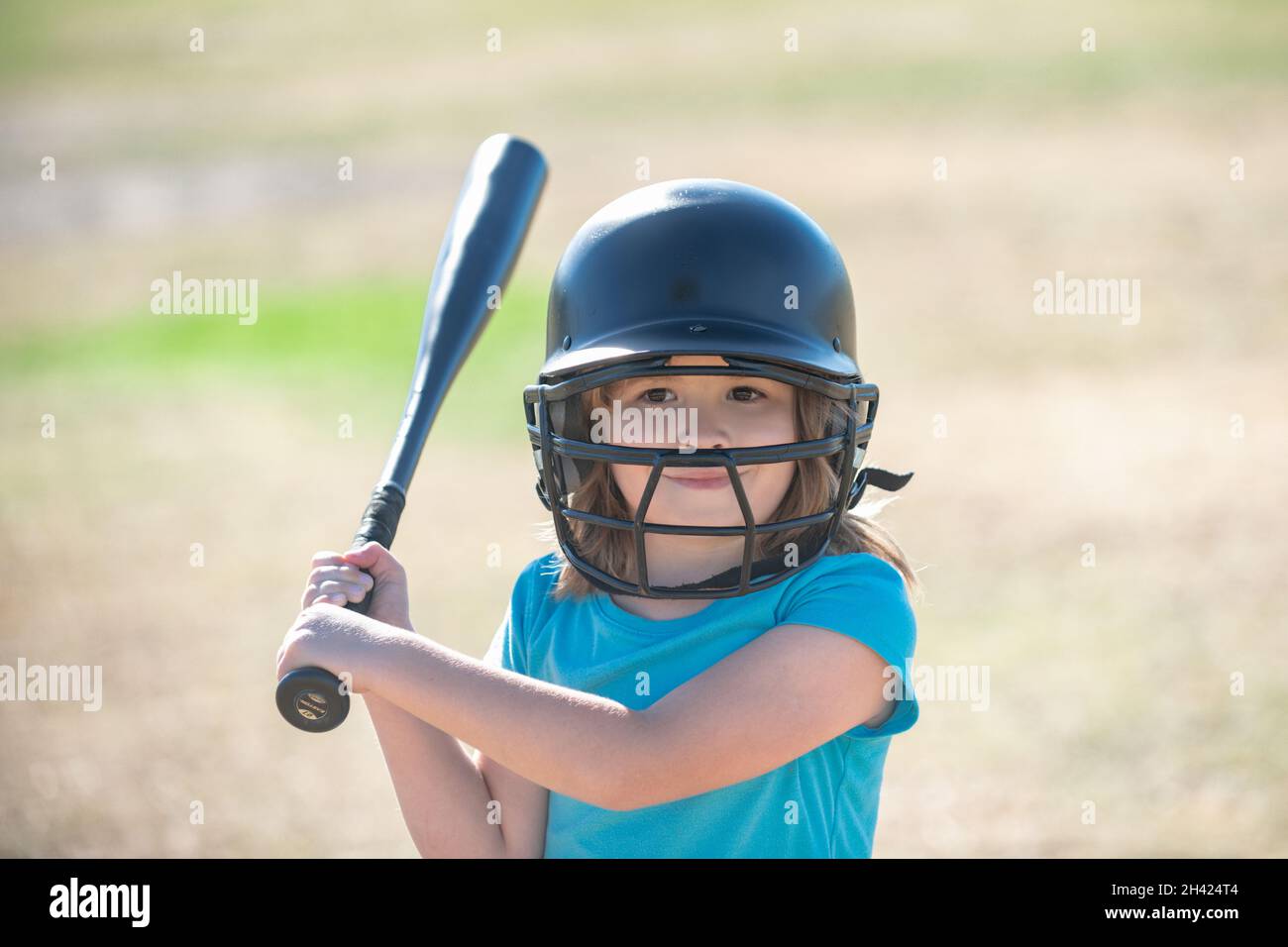 Little child baseball player focused ready to bat. Kid holding a
