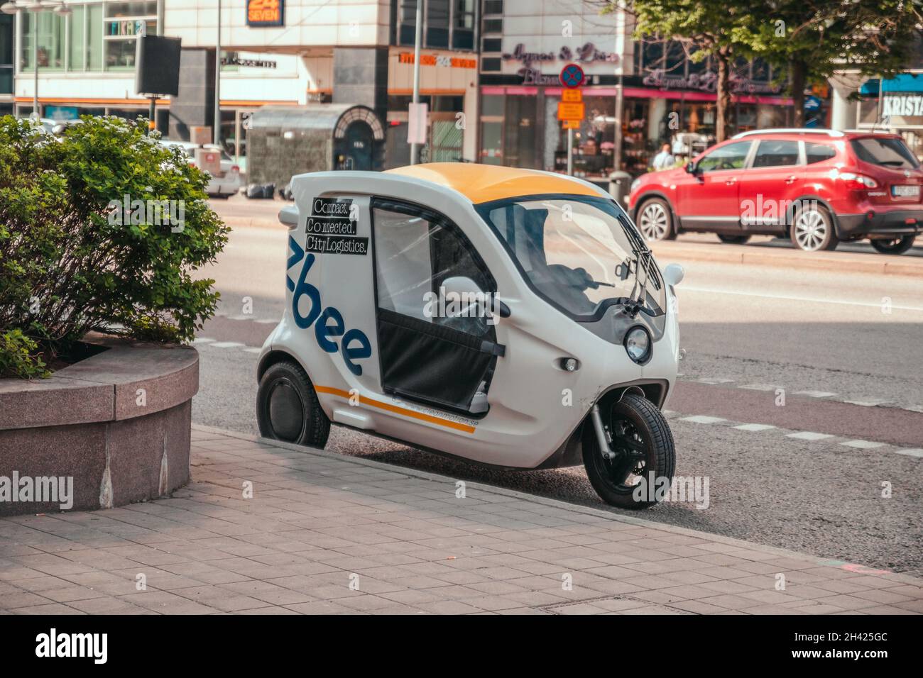 Stockholm, Sweden - June 7, 2019: White three wheeler commercial vehicle in the road. Rental motorbikes on parking Stock Photo