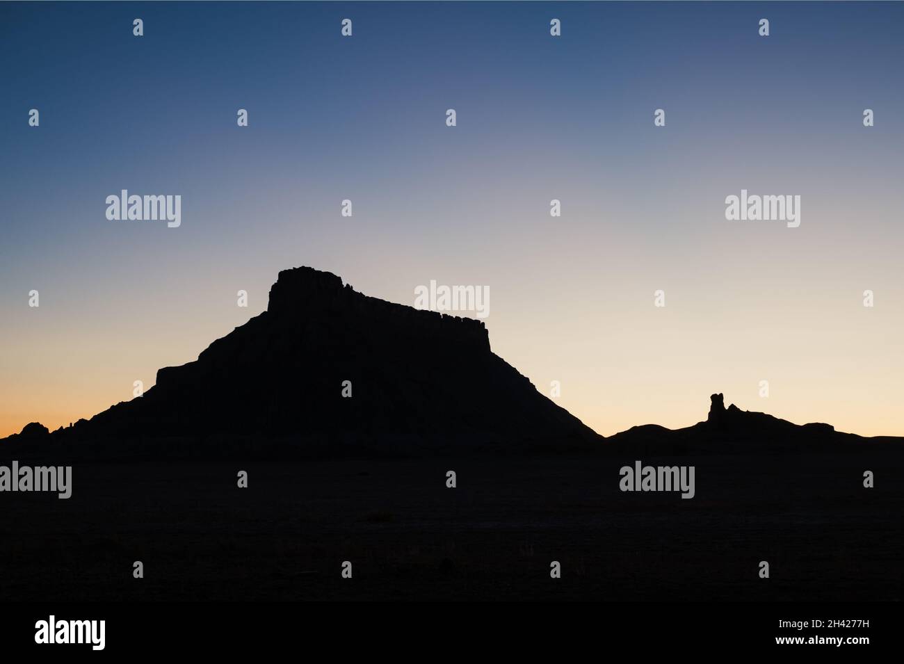 Silhouette of Factory Butte in Utah at dawn Stock Photo