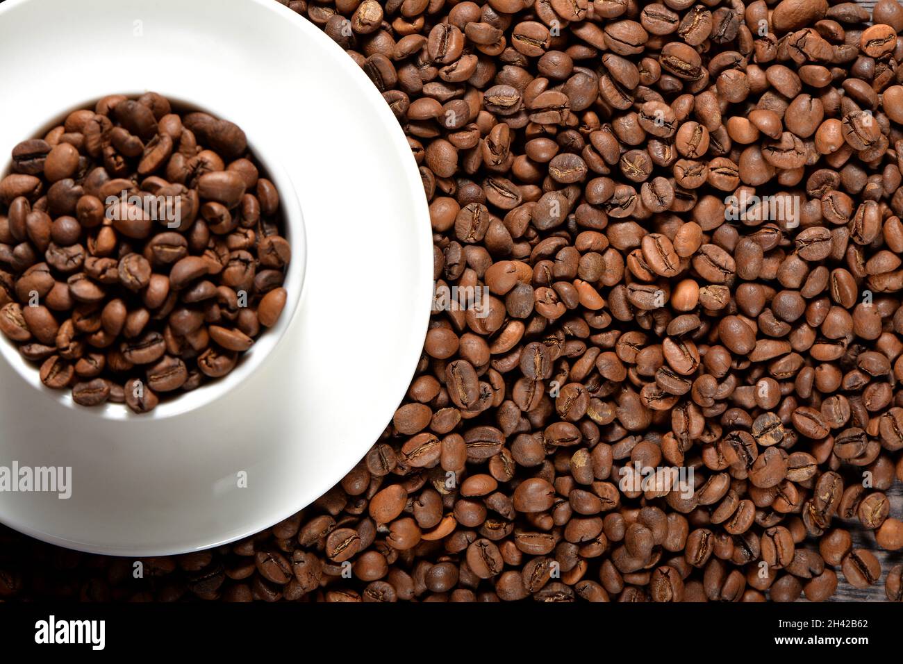 White coffee mug filled with coffee beans Stock Photo