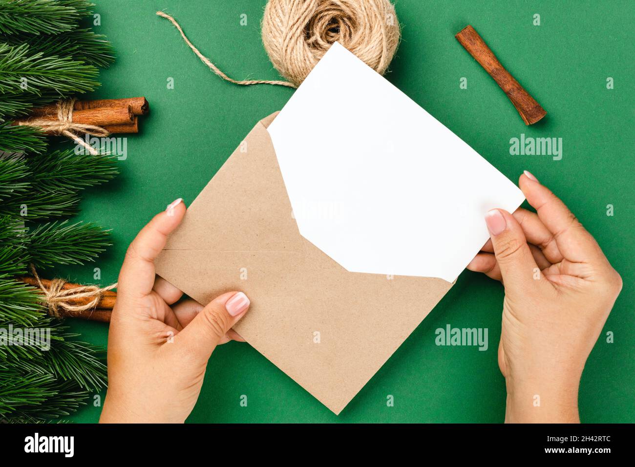 woman hands send letter with Christmas greetings in frame of fir ...