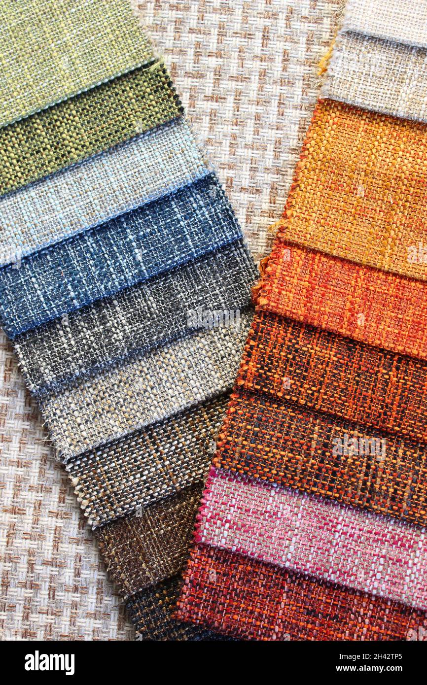 Samples of colorful upholstery fabrics. Various texture and colors. Stock Photo
