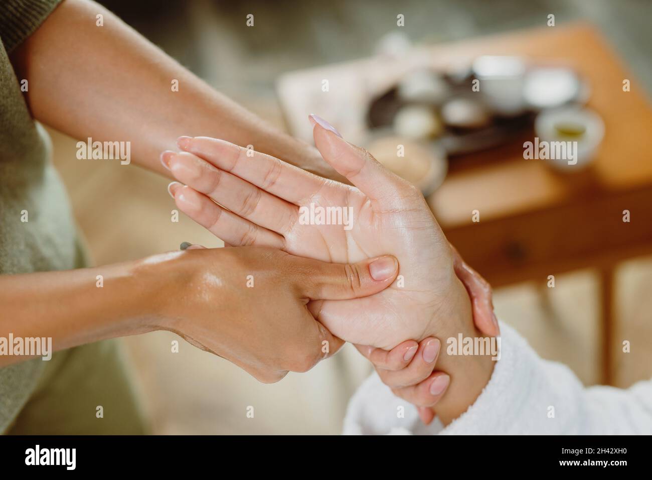 Female receiving hand massage at health spa salon. Stock Photo