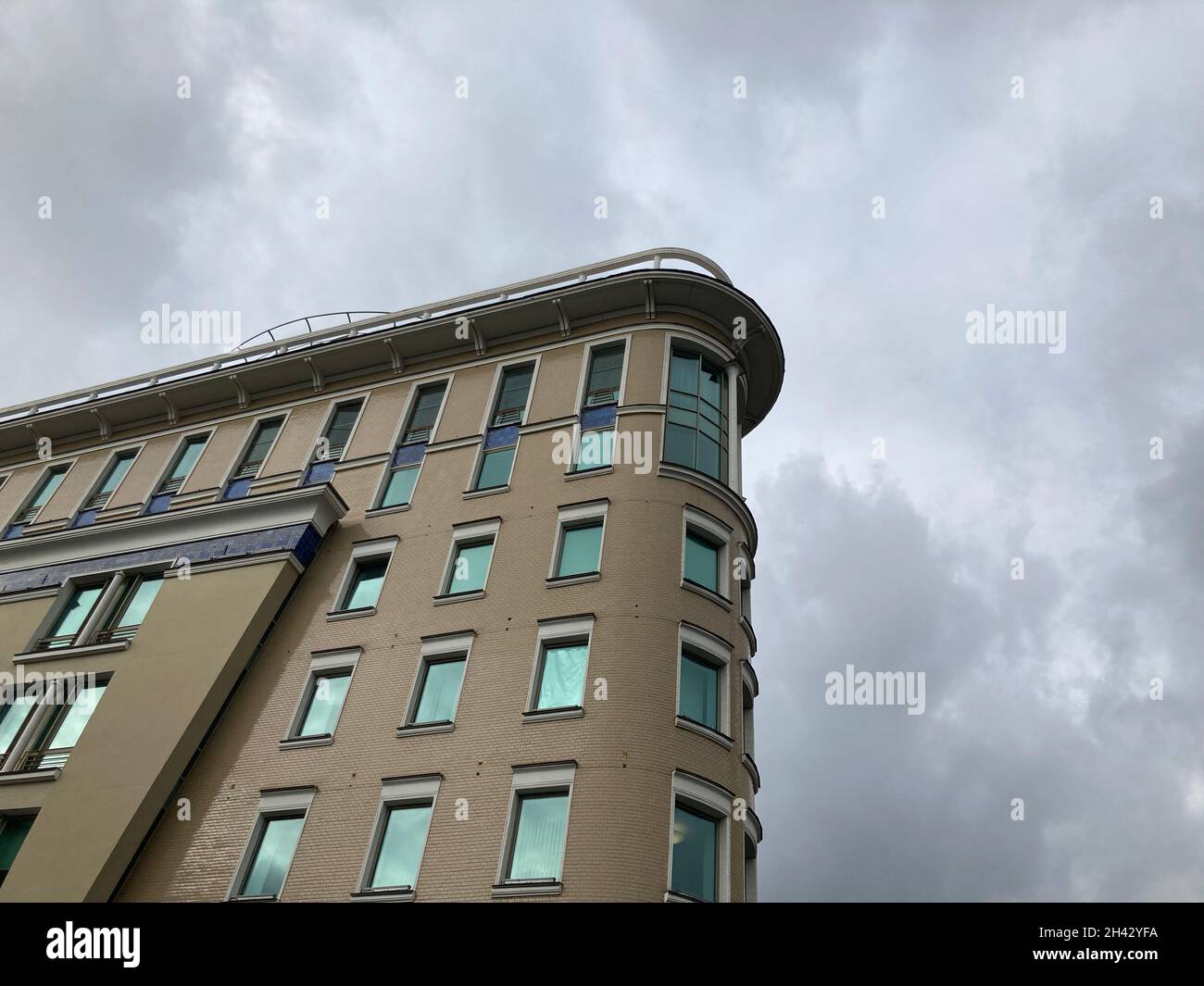 Facade of architectural building against cloudy sky in downtown ...