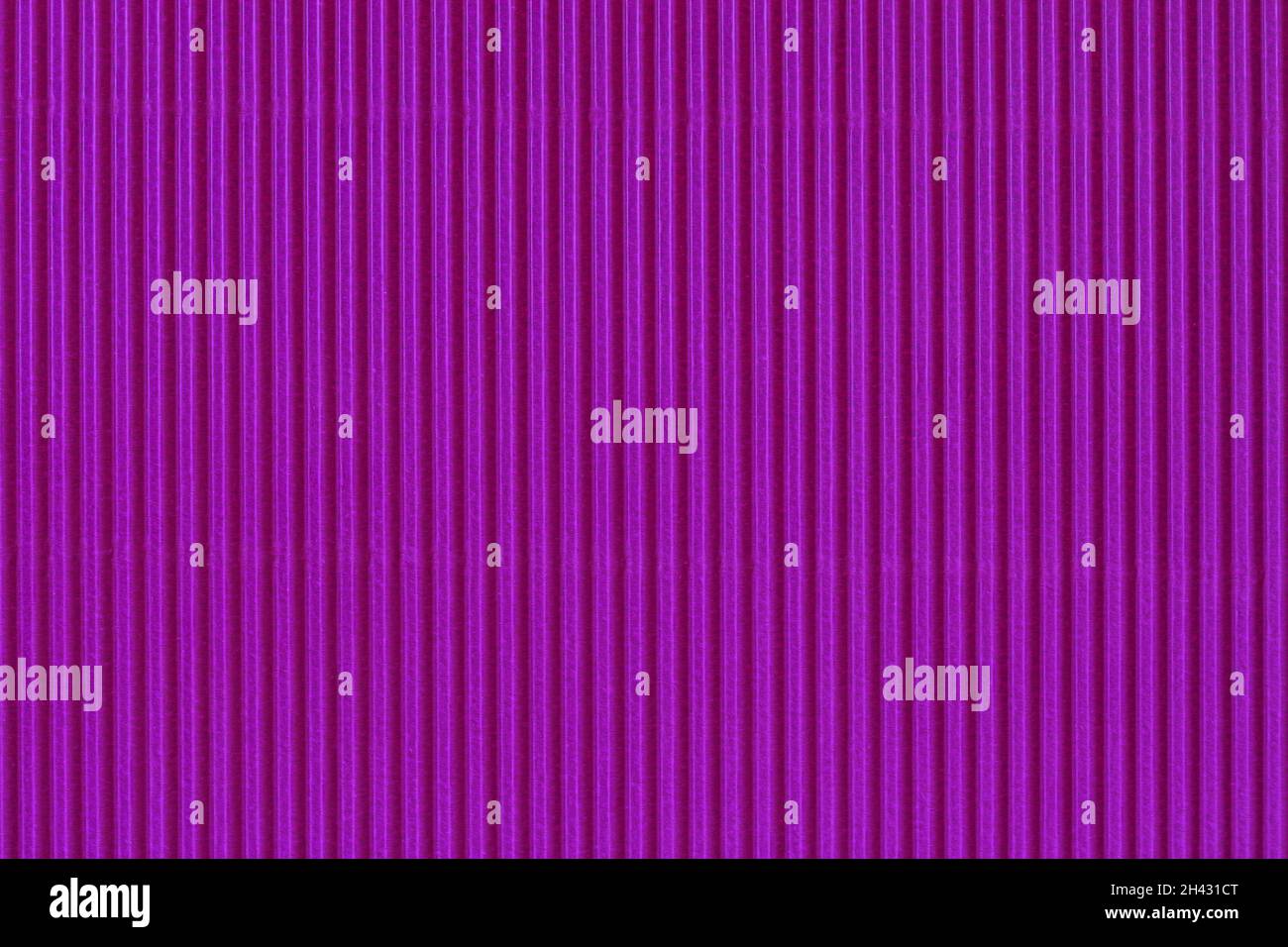 Abstract corrugated texture of vibrant bright purple color. Striped pattern closeup Stock Photo