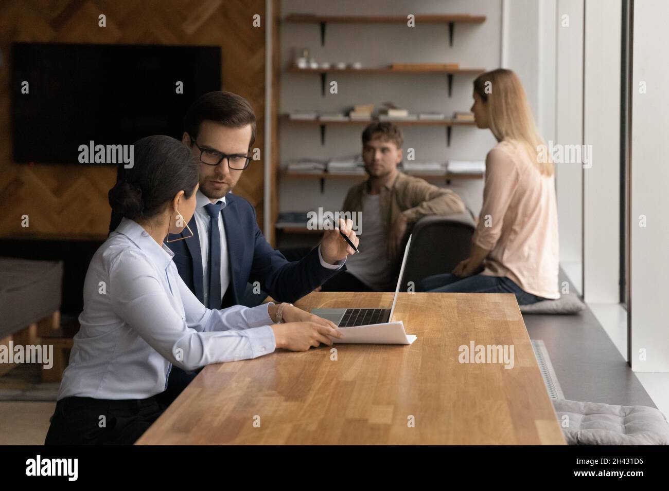 Concentrated mixed race colleagues working on computer. Stock Photo