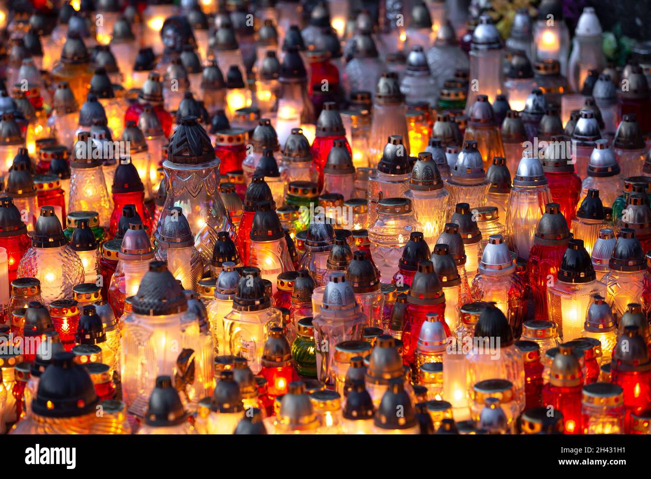 Candles burning at a cemetery during the All Saints Day Stock Photo