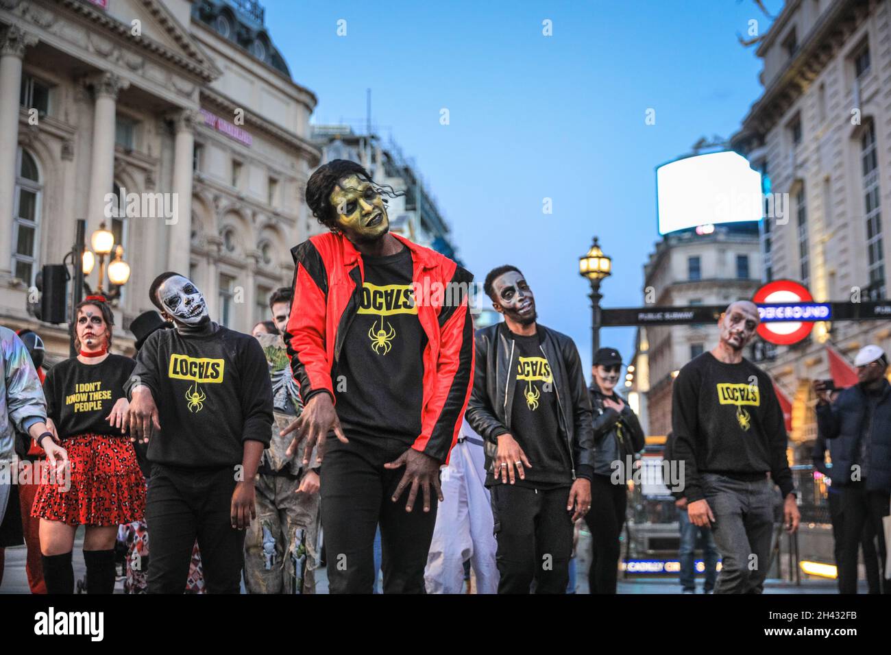 Piccadilly Circus, London, UK. 31st Oct, 2021. The dancers re-create the famous zombie dance scenes from Michael Jackson's 'Thriller' video. Revellers take part in a Halloween dance flashmob, including a group from Locals.org, a London-based social platform and meet up designed to bring Londoners together. Passers-by are encouraged to join in and dance, too. Credit: Imageplotter/Alamy Live News Stock Photo