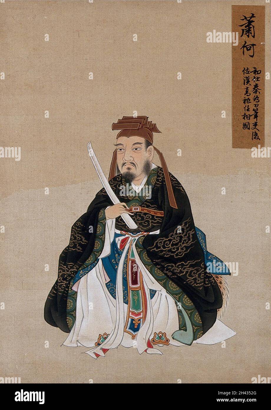 A Chinese figure wearing black silk robes with a green border, richly decorated with cloud scroll designs in gold thread. Painting by a Chinese artist, ca. 1850. Stock Photo