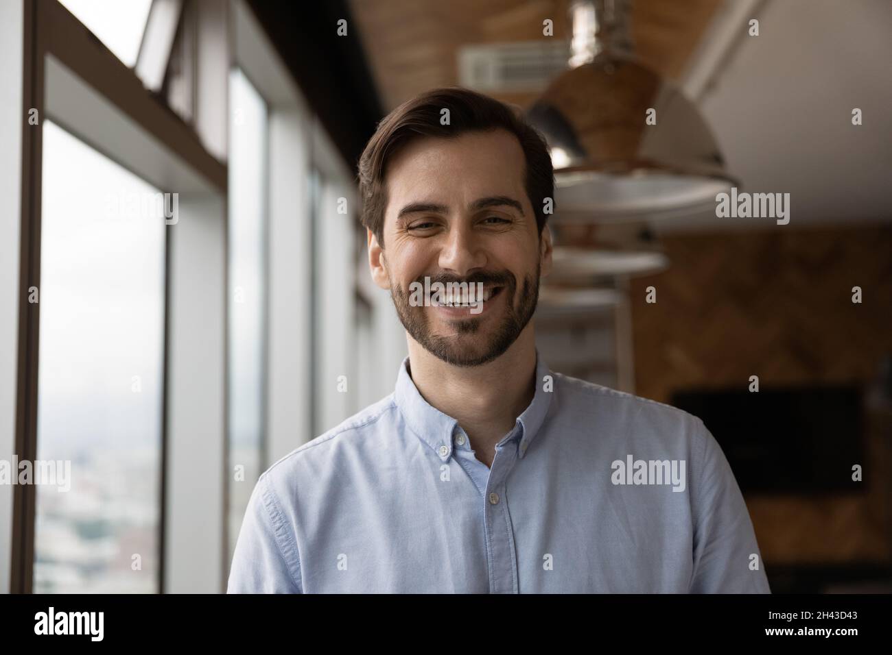 Happy candid young caucasian man looking at camera. Stock Photo