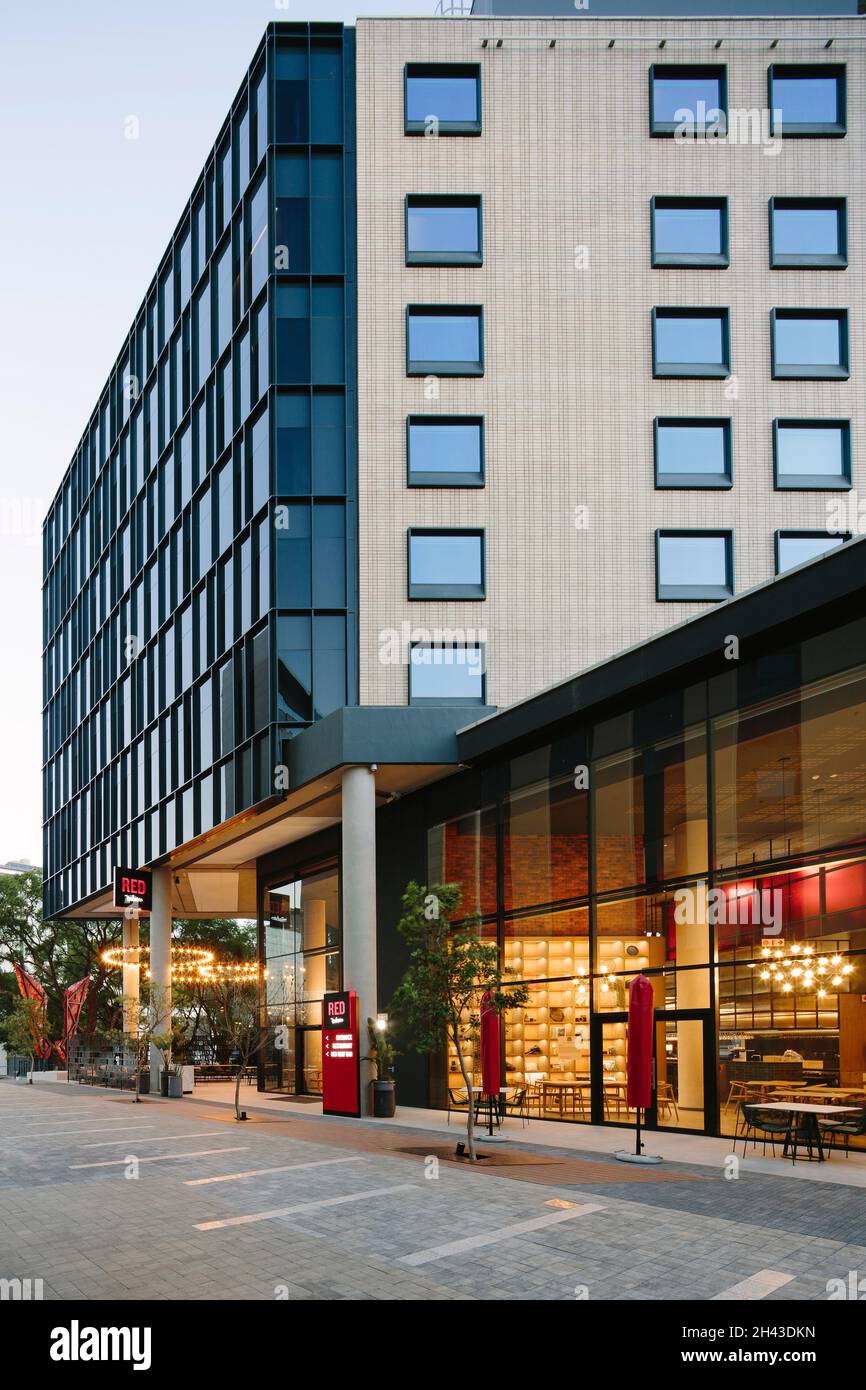 The North and West facades above the restaurant as approached from the main precinct boulevard. Radisson RED Rosebank, Johannesburg, South Africa. Arc Stock Photo