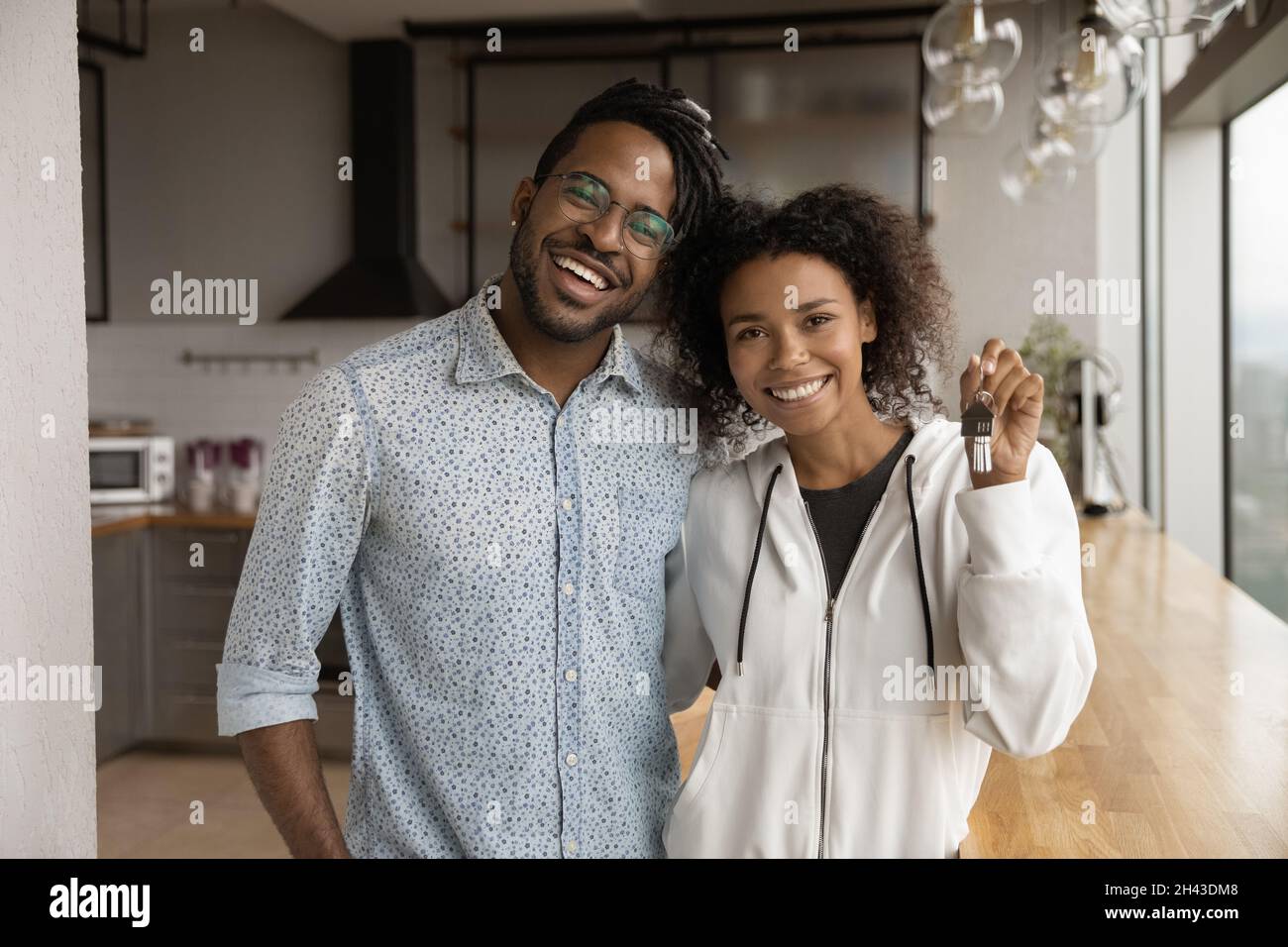 Happy young african american family couple showing key Stock Photo - Alamy