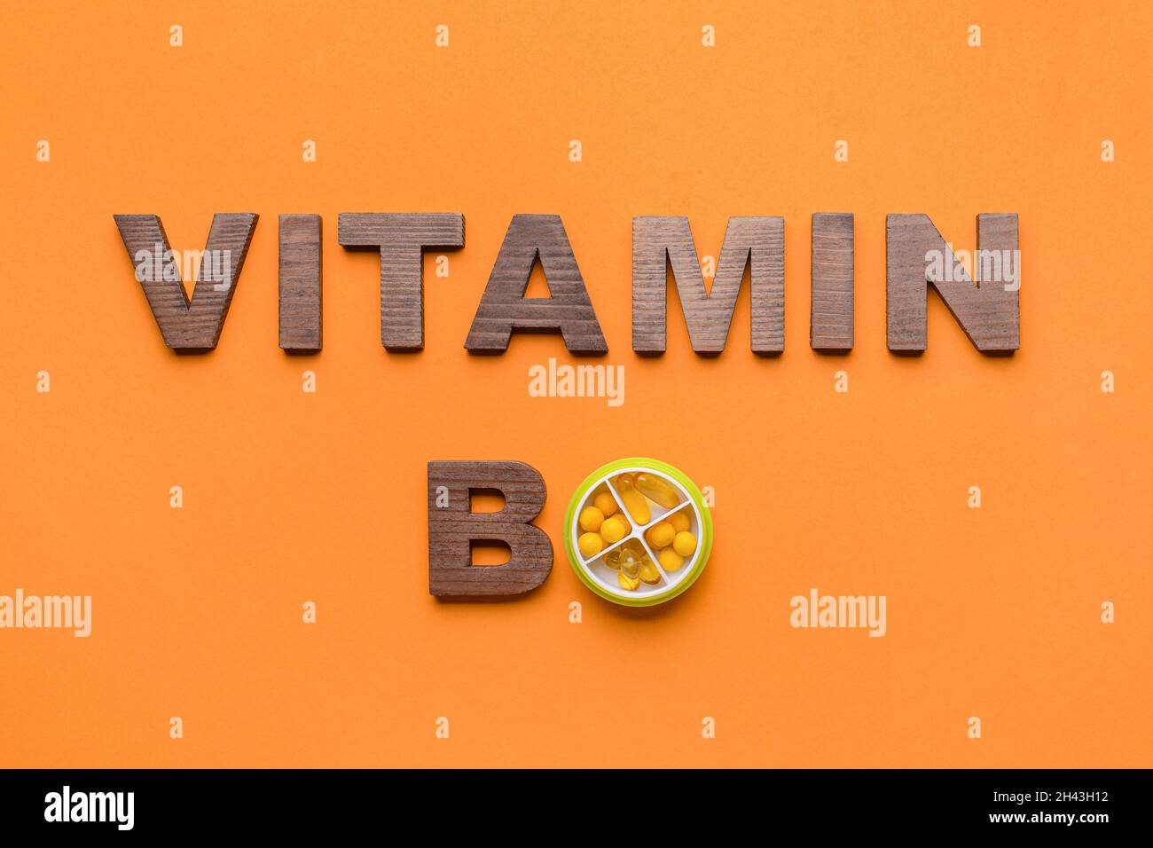 Text VITAMIN B with pills on color background Stock Photo