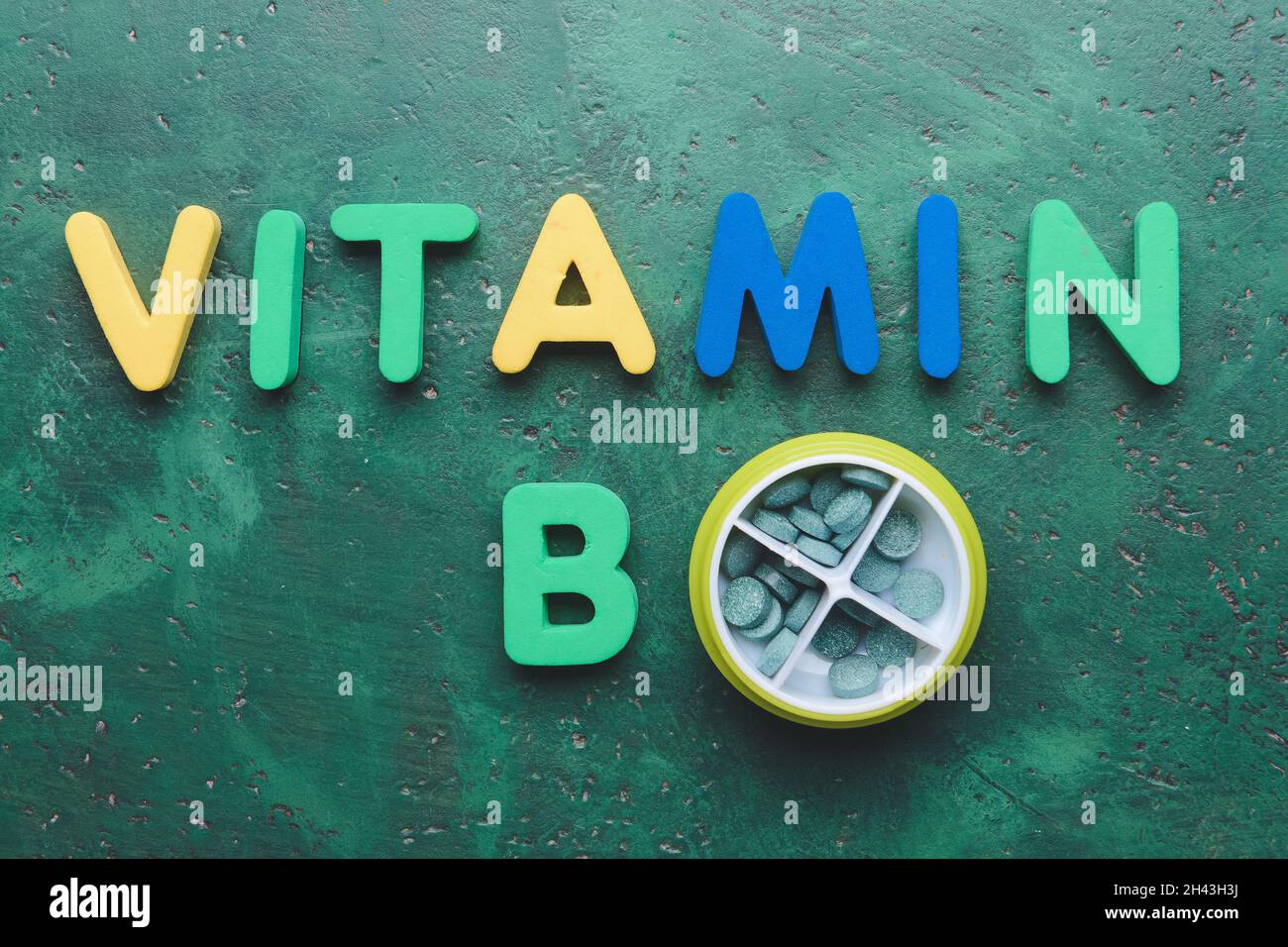 Text VITAMIN B with pills on color background Stock Photo