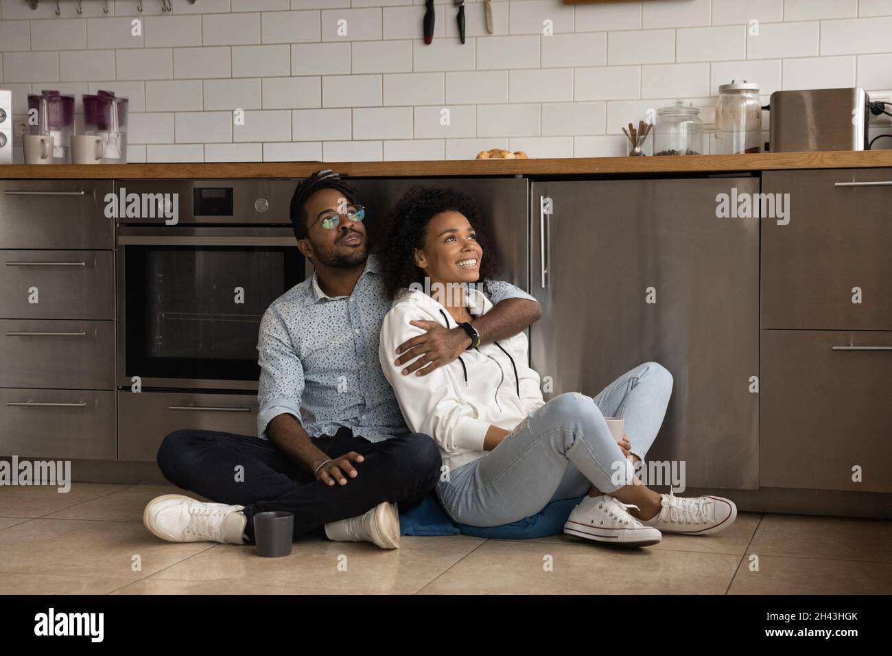 Happy biracial woman sitting on hi-res stock photography and images - Alamy