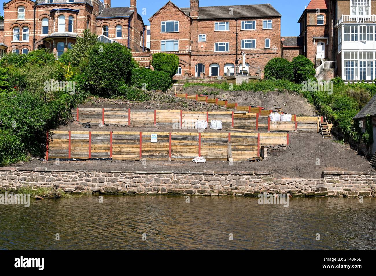 Chester, England - July 2021: Landscape gardening work being undertaken on a steep garden sloping down to the banks of the River Dee in Chester Stock Photo