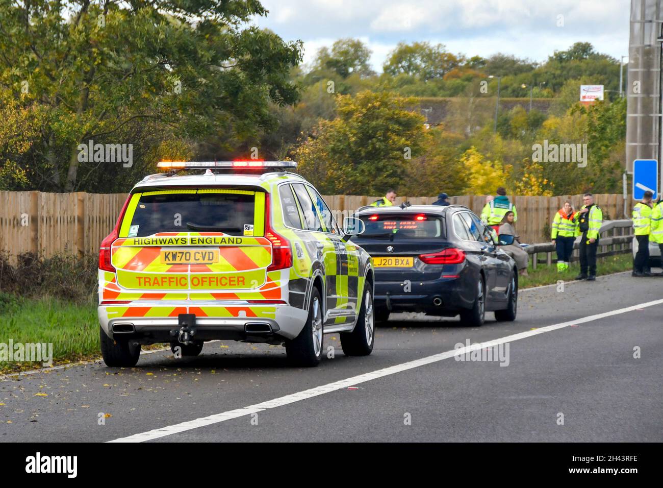 Strensham, England - October 2021: Traffic officer patrol car on the hard shoulder of the M5 motorway with flashing lights to warn of an accident Stock Photo
