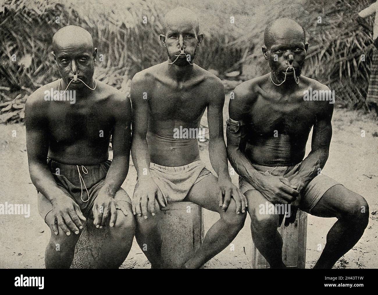 Three seated pearl divers, wearing nose clips. Halftone Stock Photo Alamy