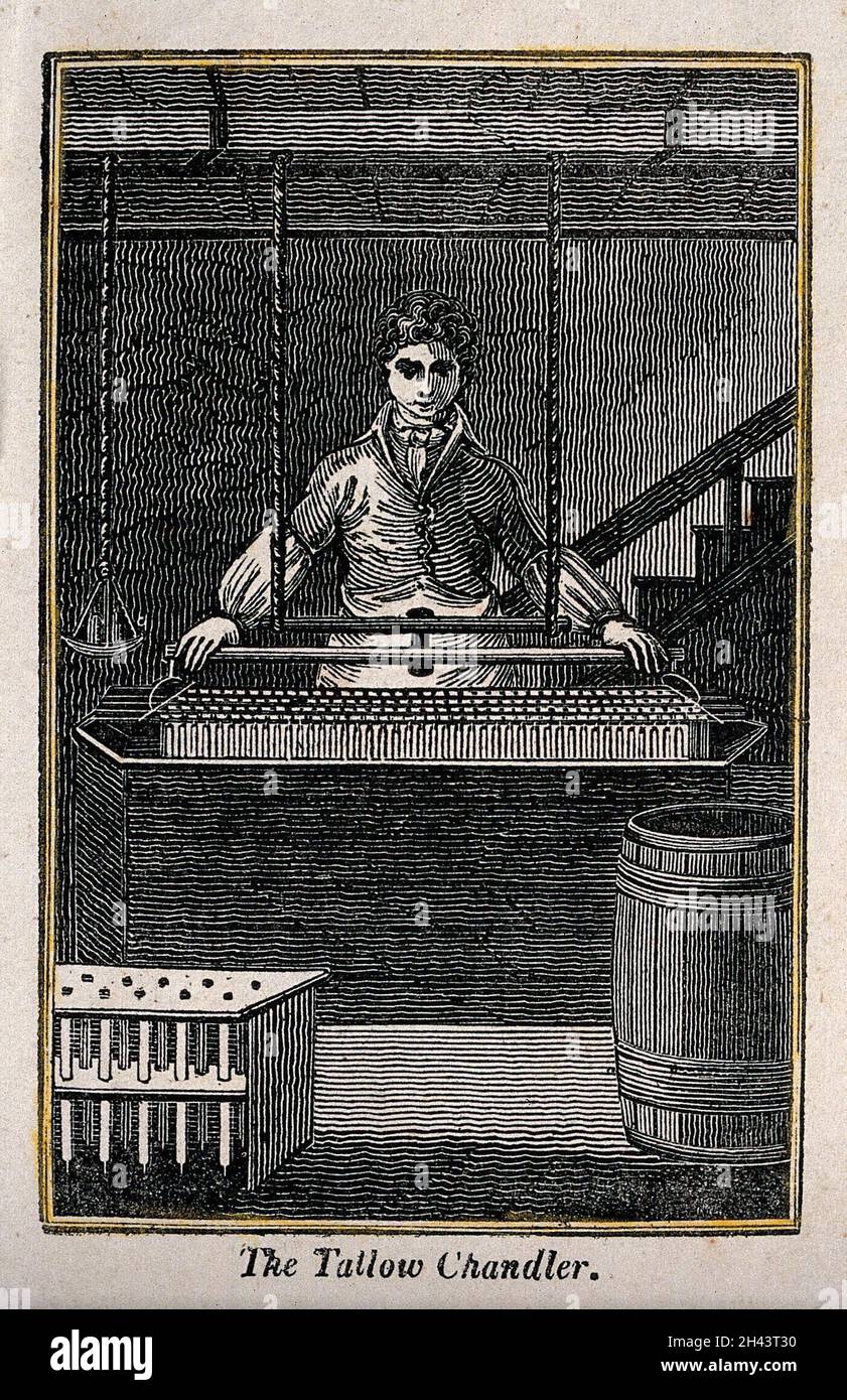 A man stands with a large container which he is lowering into a vat