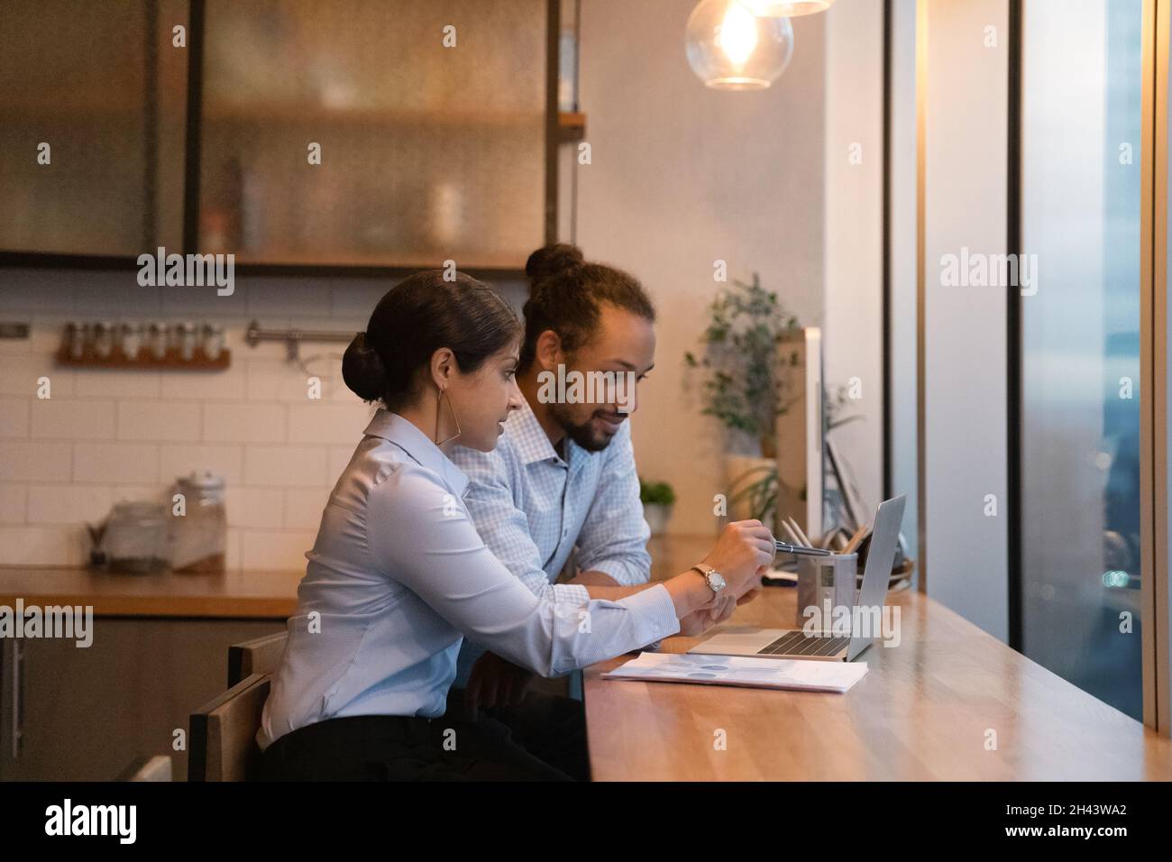 Concentrated mixed race employees working on computer. Stock Photo