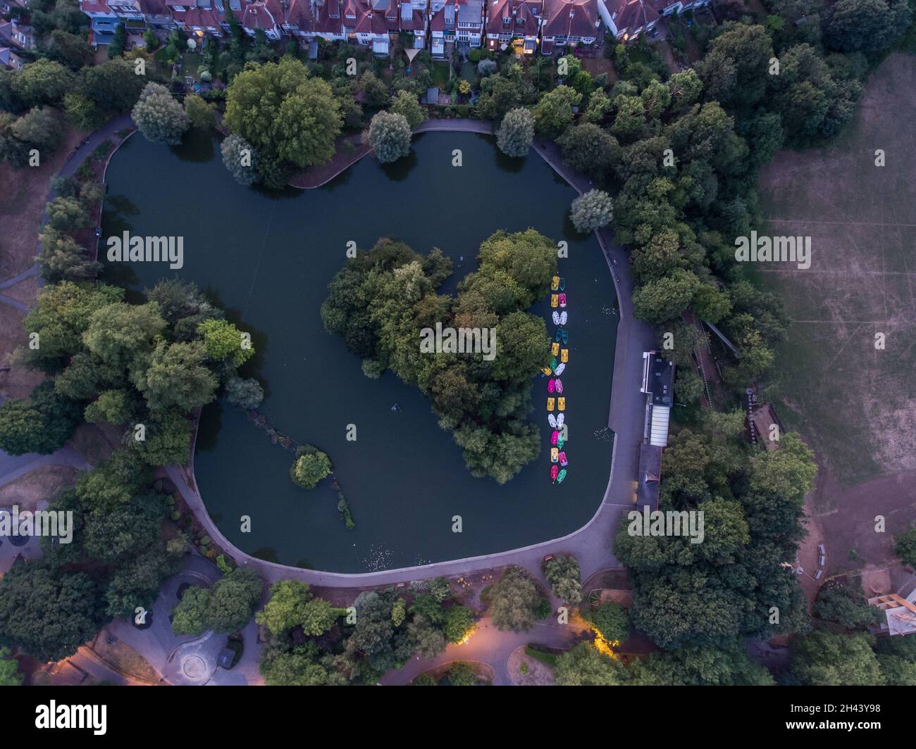 Top down aerial view of colorful boats in lake at Alexandra Palace in North London Stock Photo
