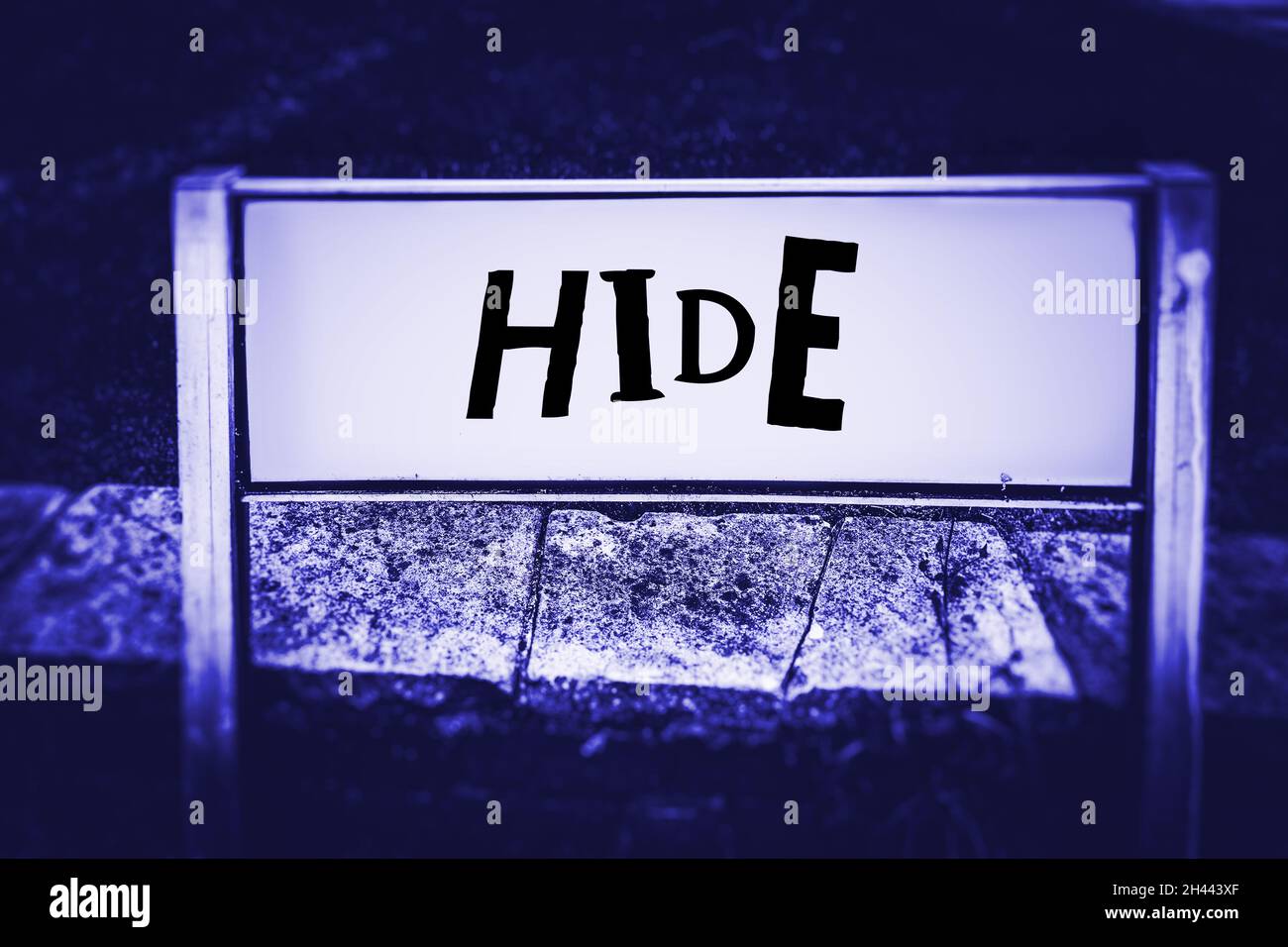 Hide written on a street sign in a neon blue tone Stock Photo