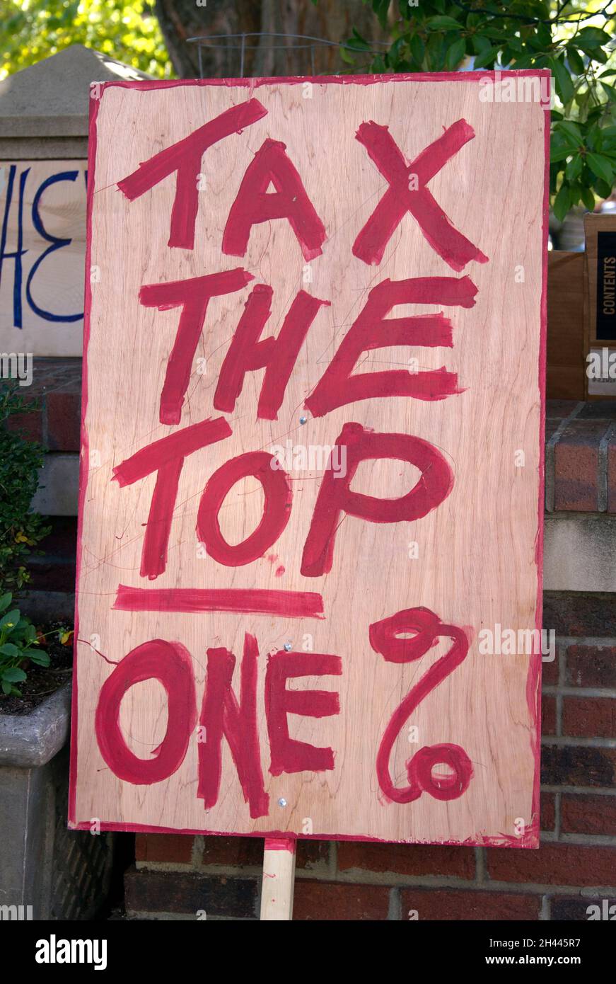 2011 Occupy Wallstreet sign says 'Tax the Top One %' a progressive stance that continues to be debated. Stock Photo