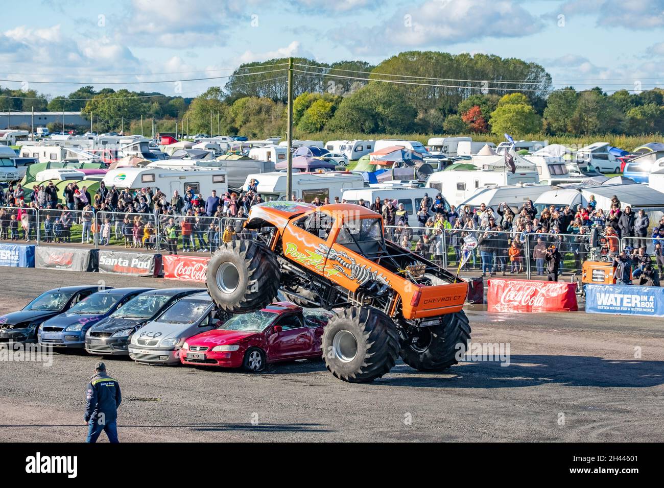 The Podzilla monster truck jumping cars during a live performance at