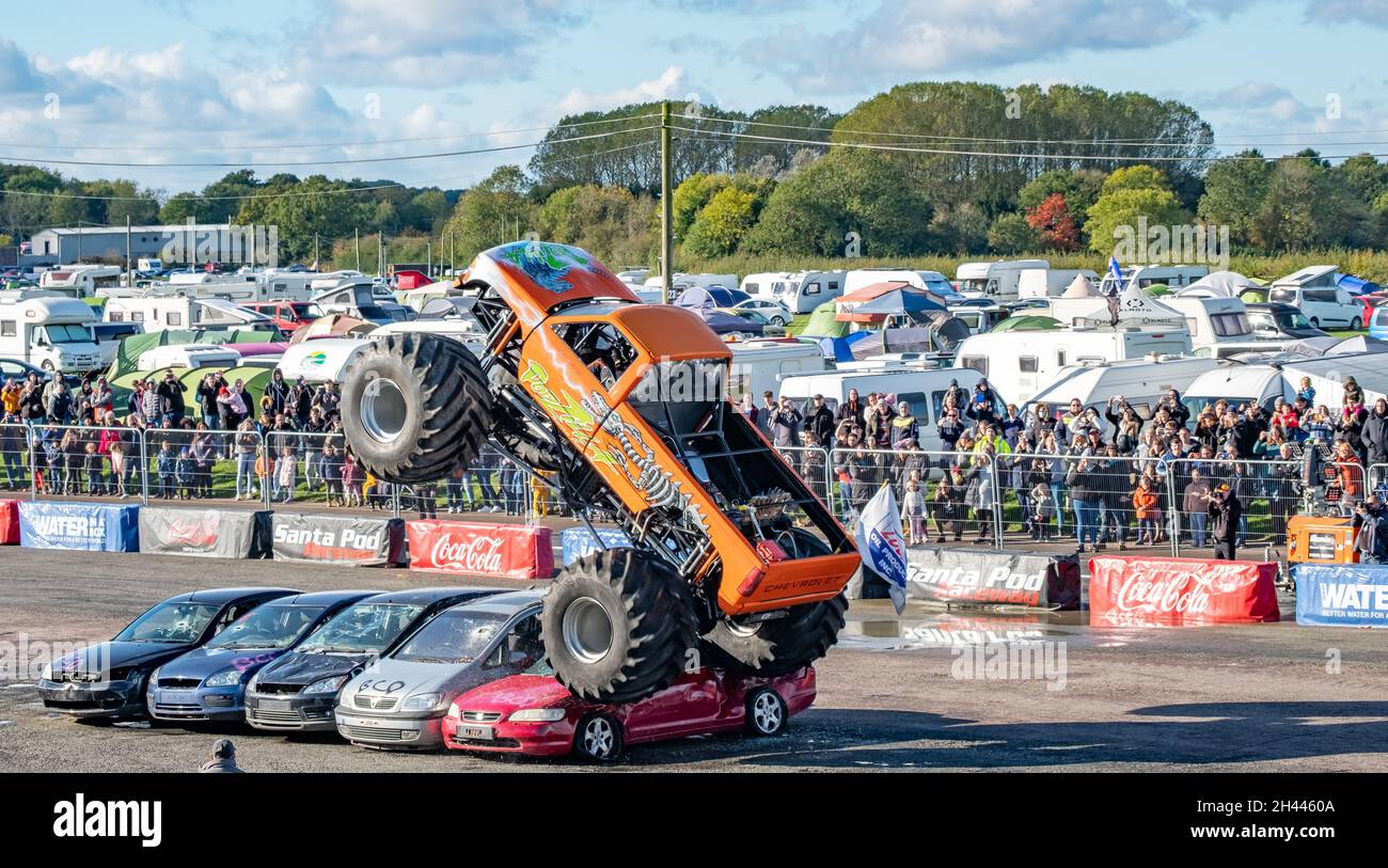 The Podzilla monster truck jumping cars during a live performance at ...