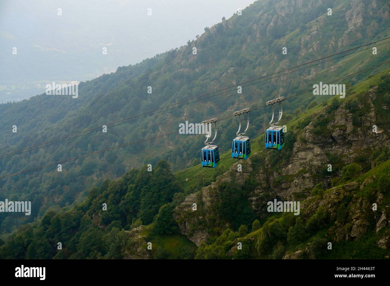 Cable car cabins move through the mountains Stock Photo - Alamy