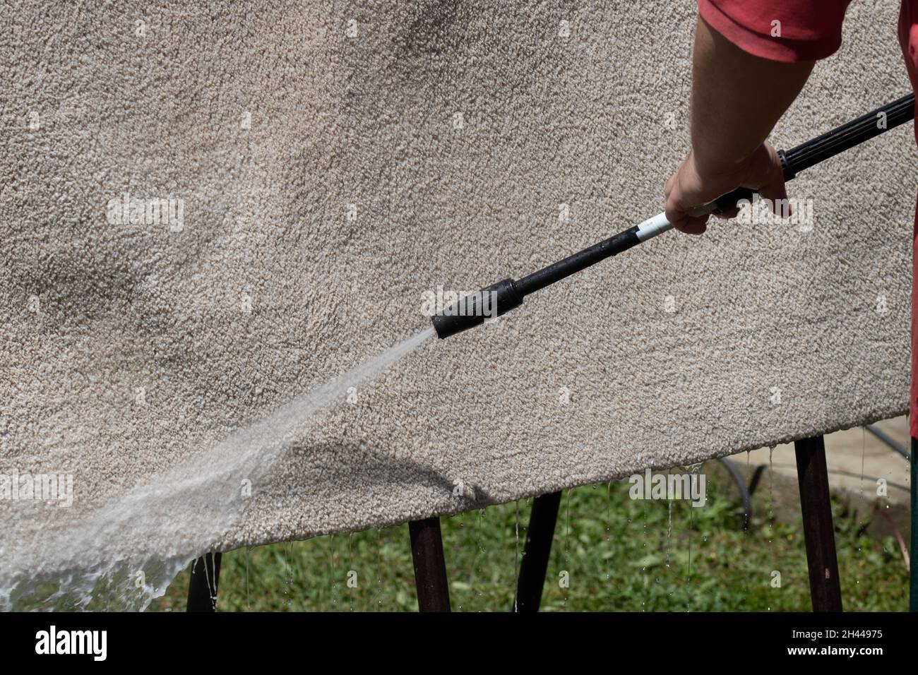 Washing carpets with high pressure washer. Cleaning the carpet with a