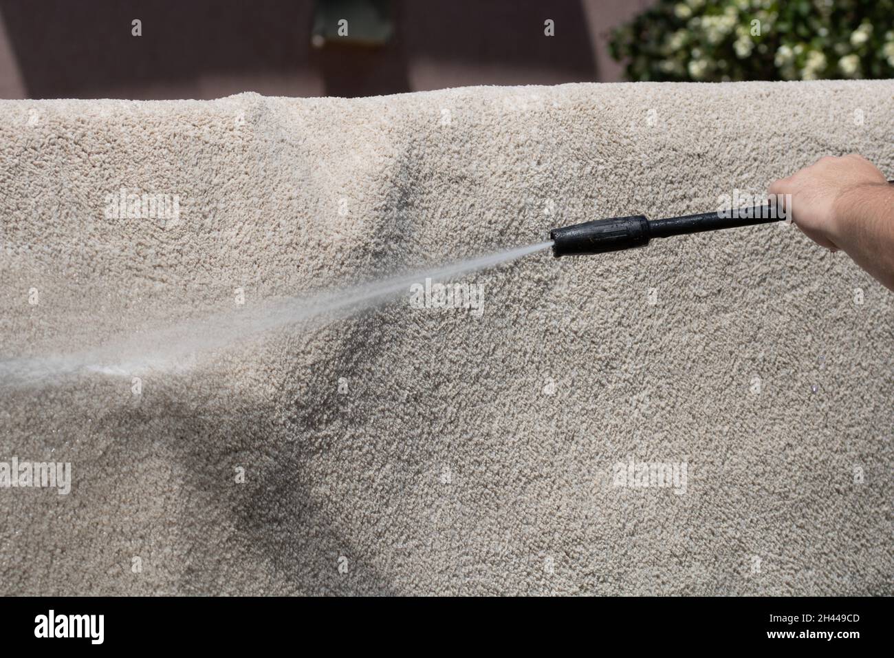 Washing carpets with high pressure washer. Cleaning the carpet with a